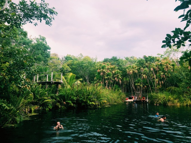 Cenote Cristal in Tulum with a jumping platform and a few people.